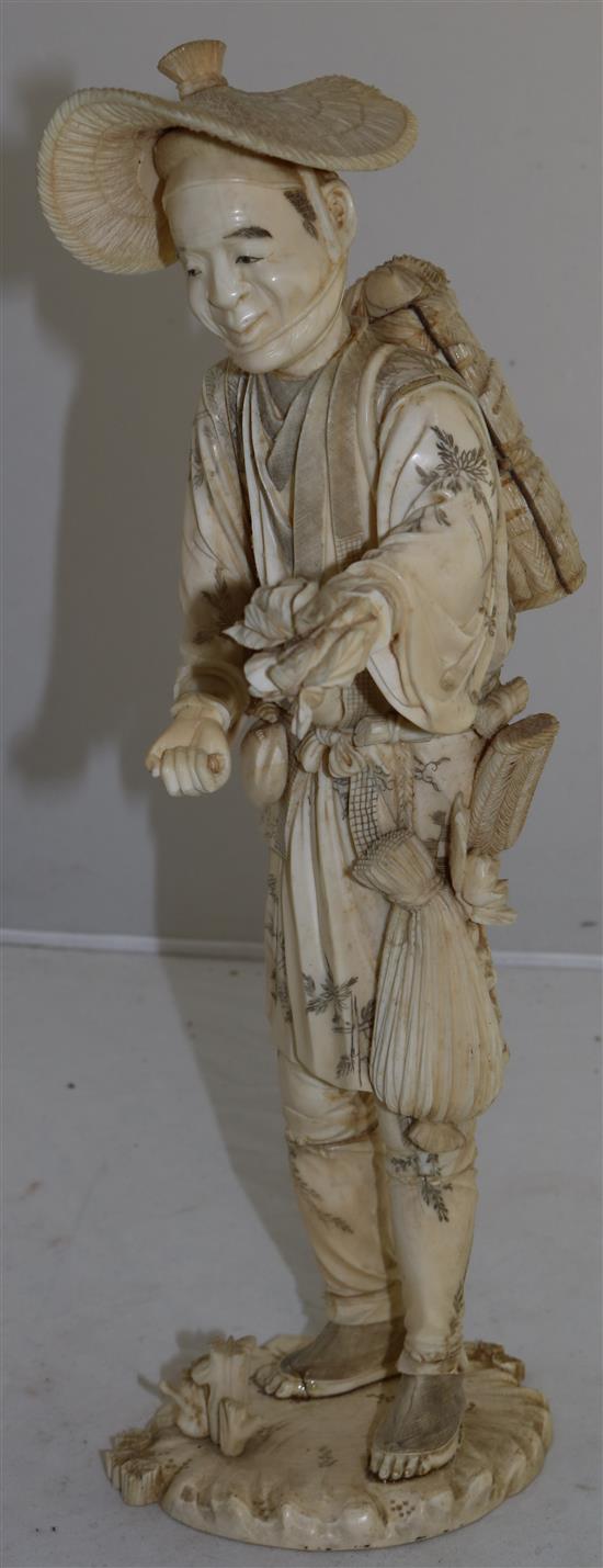 A large Japanese sectional ivory figure of a farmer, early 20th century, 36.5cm